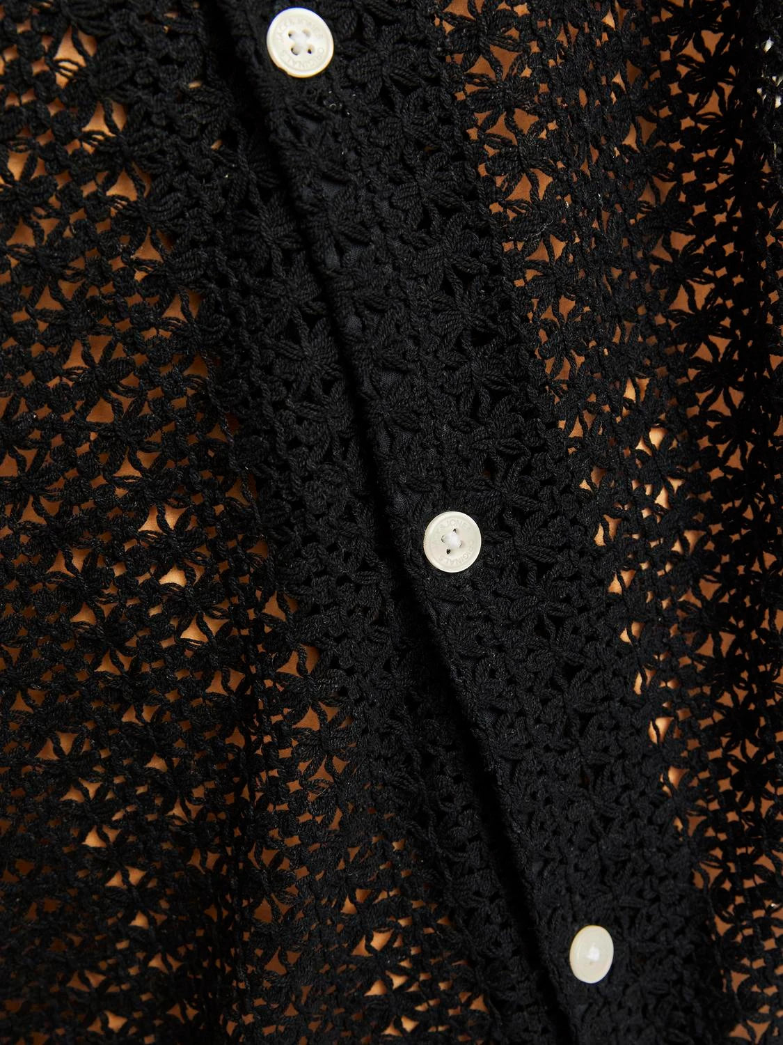Nahaufnahme des Jack&Jones Crochet Shirt Black mit weißen Knöpfen und gehäkeltem Stoffmuster.