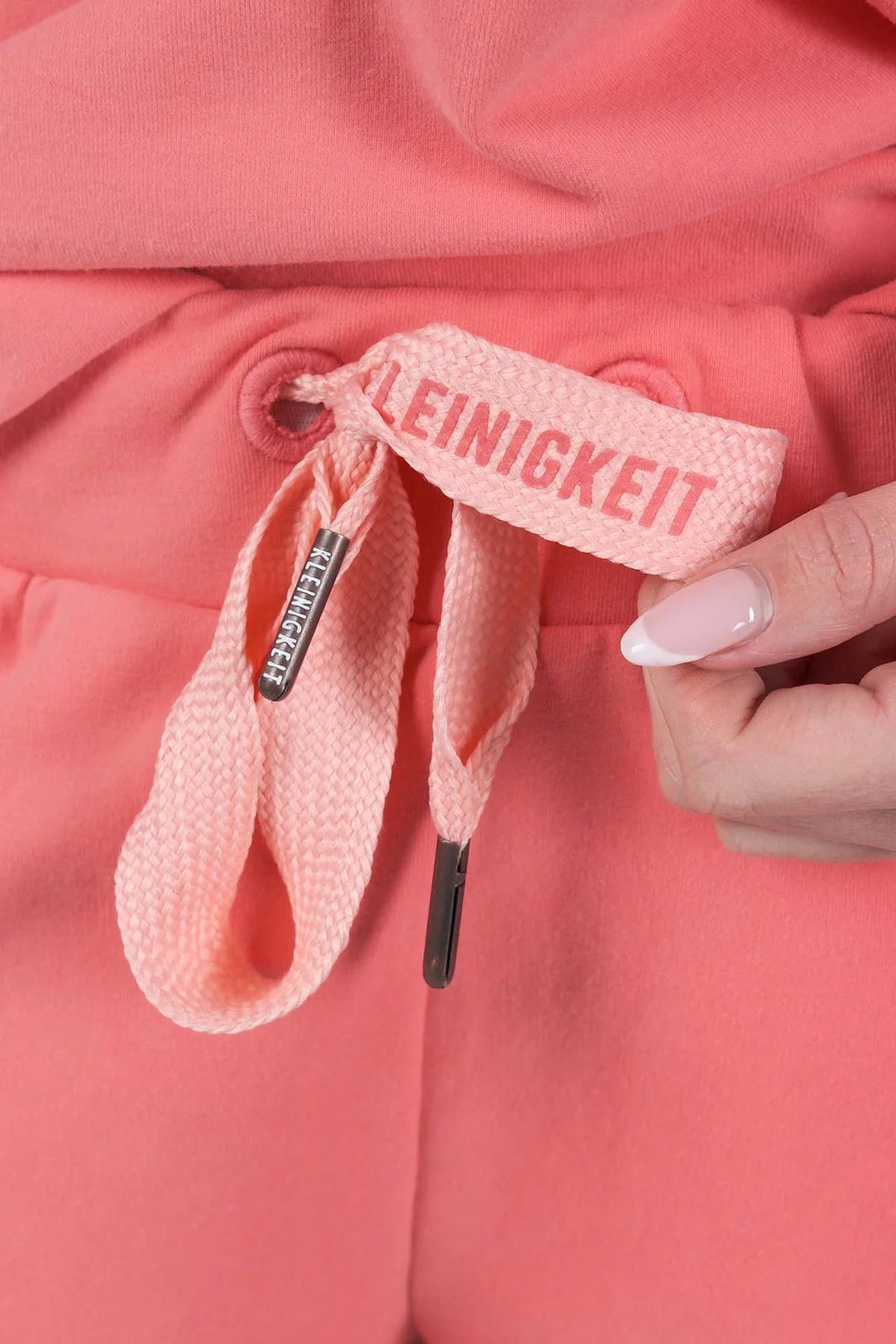 Nahaufnahme des Tunnelzugs mit Kleinigkeit-Logo an der Kleinigkeit Organnah Montana Shortpant Peach – stylische Details für perfekten Sitz