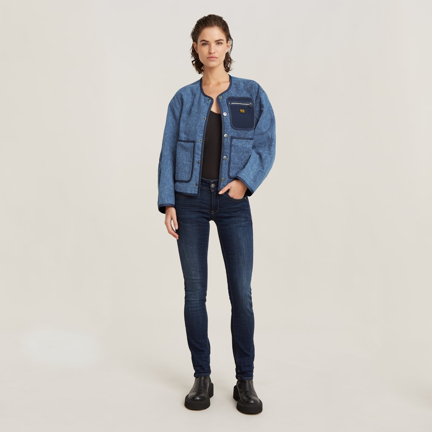G-Star Midge Straight Dark Aged Jeans kombiniert mit einer blauen Jacke und schwarzen Stiefeletten, stilvolle Ganzkörperansicht.