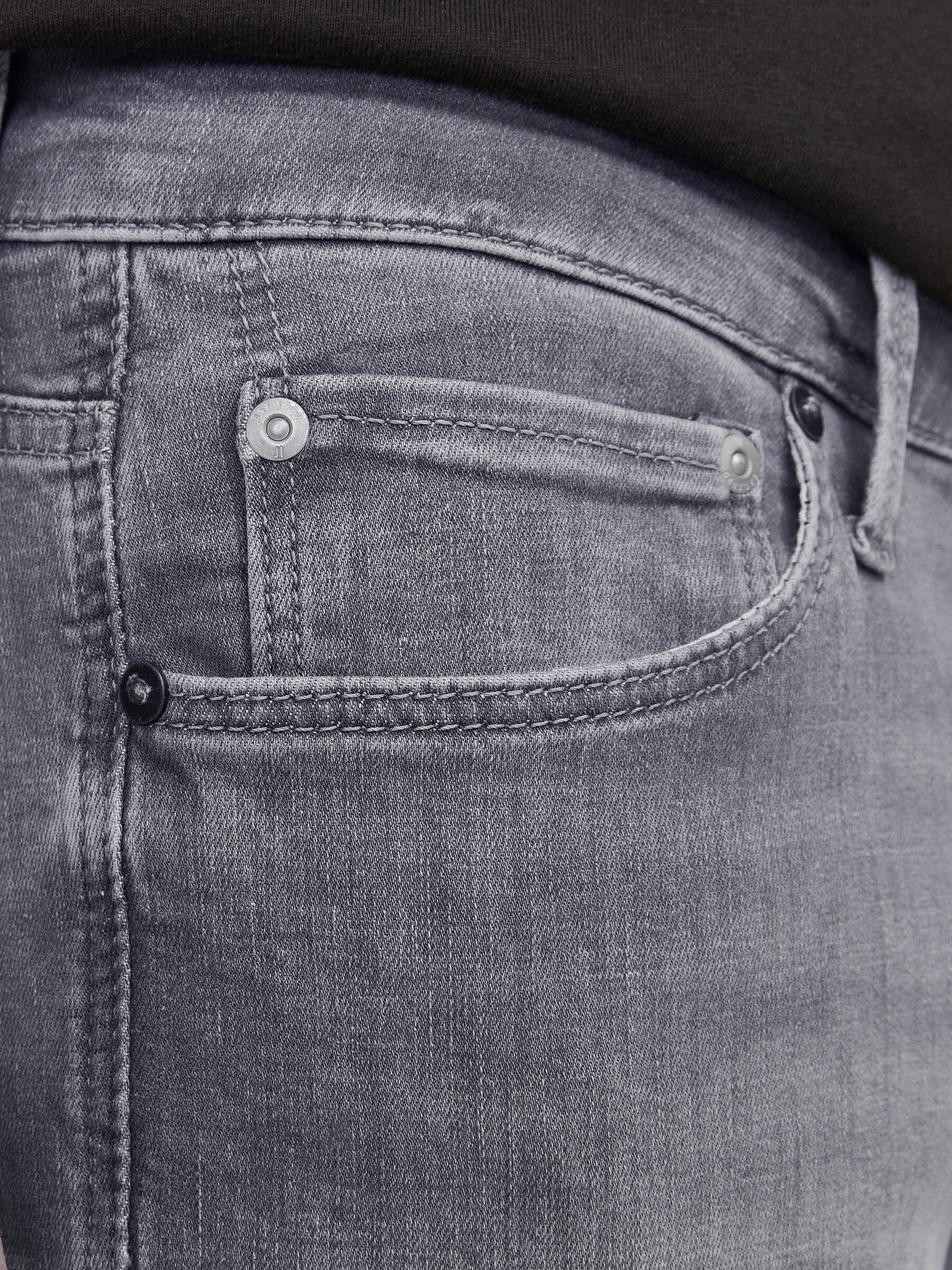 Nahaufnahme der Jack & Jones Glenn Slim Grey Denim mit detaillierter Ansicht der Vordertasche in grauem Denim-Stoff.