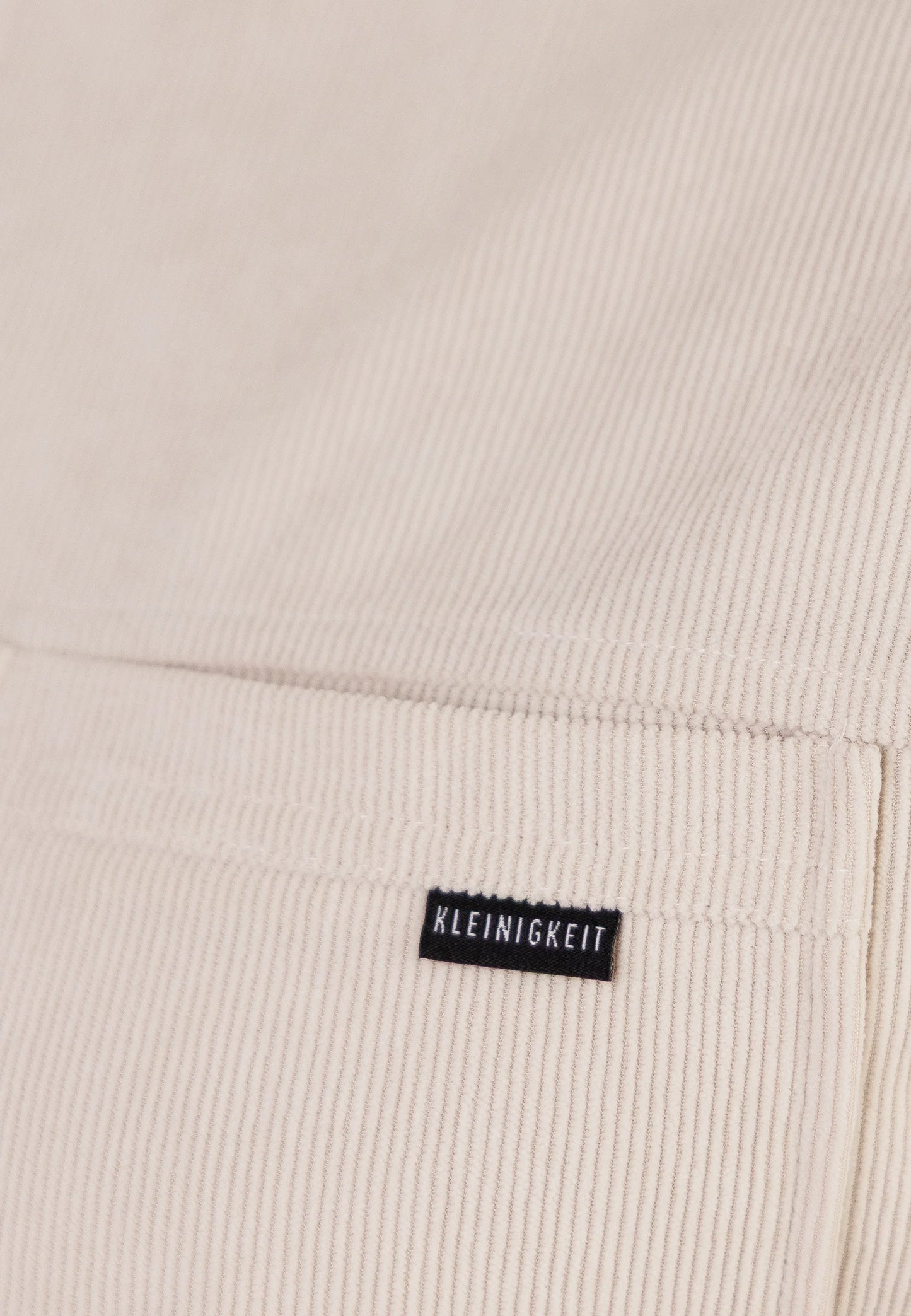 Detailaufnahme des Cordstoffs und Labels beim Kleinigkeit Cordplay Shirt - Frappe mit feiner Struktur.
