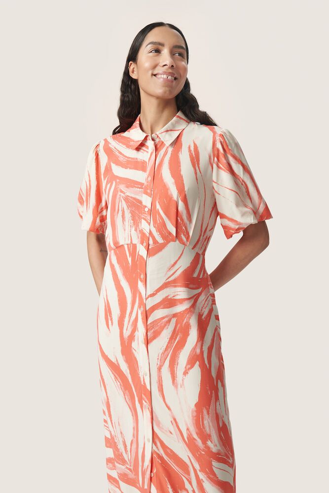 Model trägt das Soaked Wynter Midi Dress · Hot Coral Wave in halbnaher Ansicht – sommerliches Hemdblusenkleid mit auffälligem Muster und Kragen.